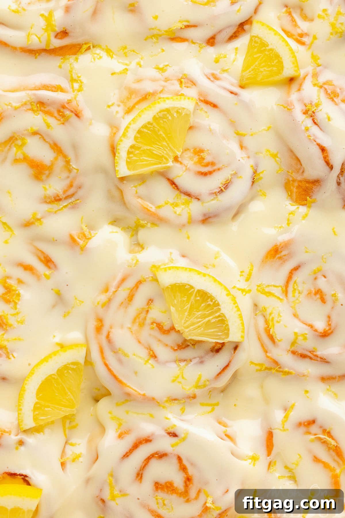 A top down view of lemon rolls in a pan.