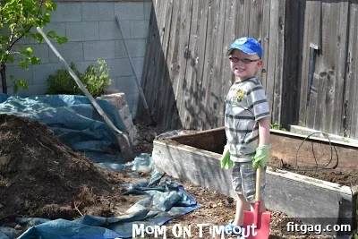 Removing the old, smaller planter box from the garden space to make room for the new one.