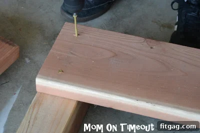 Two 2x8 boards securely fastened to a 4x4 post to form part of the planter side.