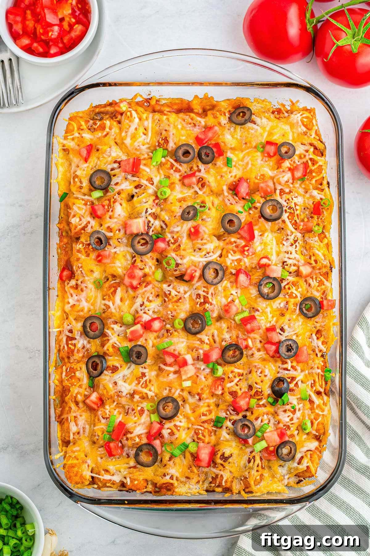 A top down view of mexican tater tot casserole in a glass pan.
