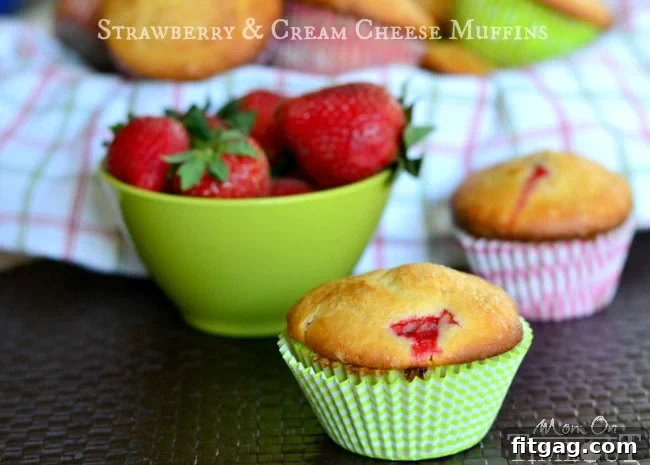 Close-up of a Strawberry Cream Cheese Muffin, showcasing its moist texture and vibrant strawberry pieces