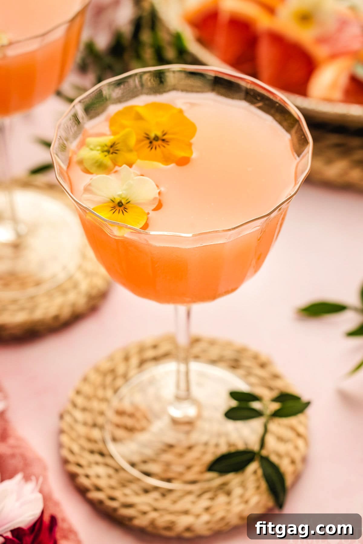 A French Blonde Cocktail elegantly presented in a coupe glass, adorned with delicate edible flowers as a beautiful and aromatic garnish, ready to be savored.