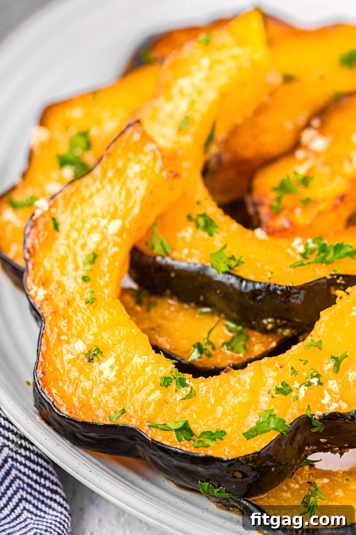 Close-up view of perfectly roasted acorn squash slices, showcasing their golden-brown edges and tender texture.