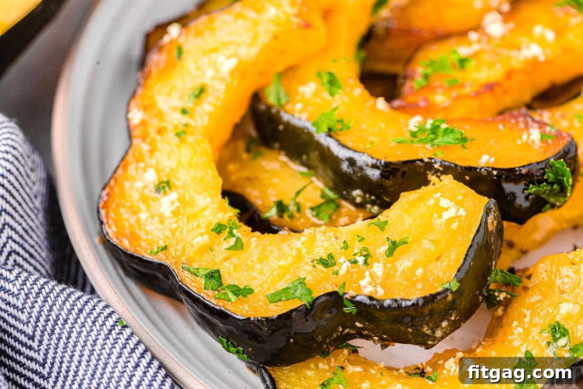 Golden Roasted Acorn Squash 6 Slices of roasted acorn squash on a plate.
