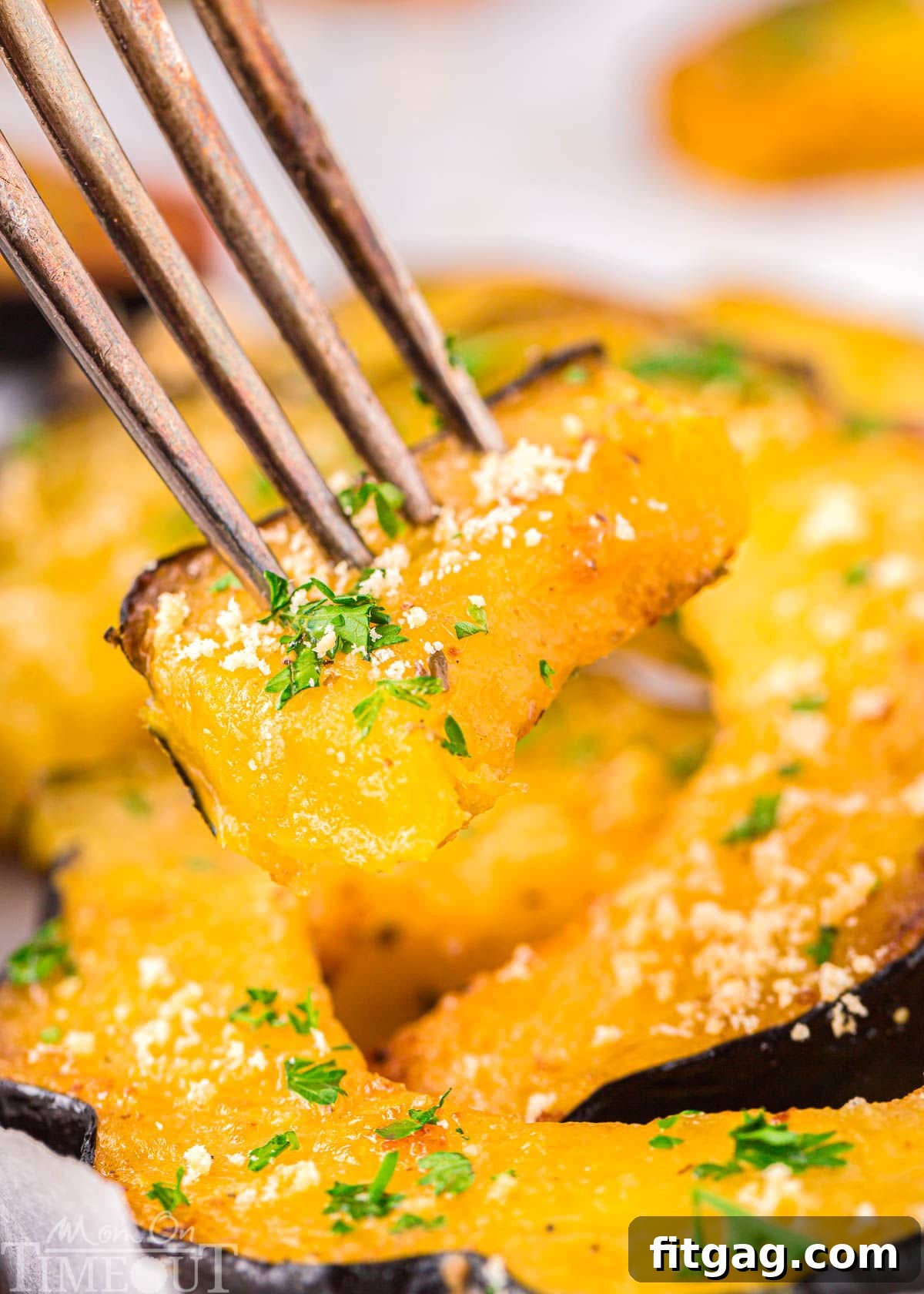 A fork piercing a tender piece of roasted acorn squash, highlighting its readiness to be enjoyed.