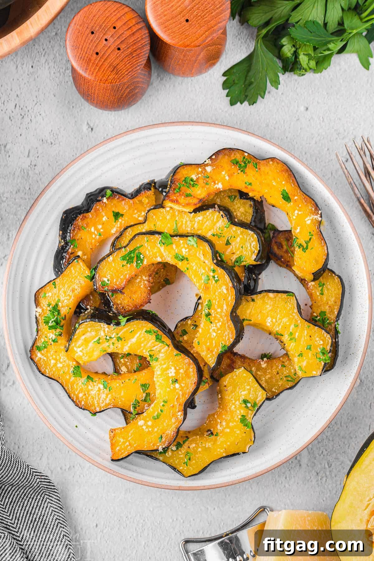 Top-down view of a beautifully plated serving of roasted acorn squash, garnished and ready to be enjoyed.