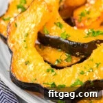 Close up of slices of acorn squash on a plate.