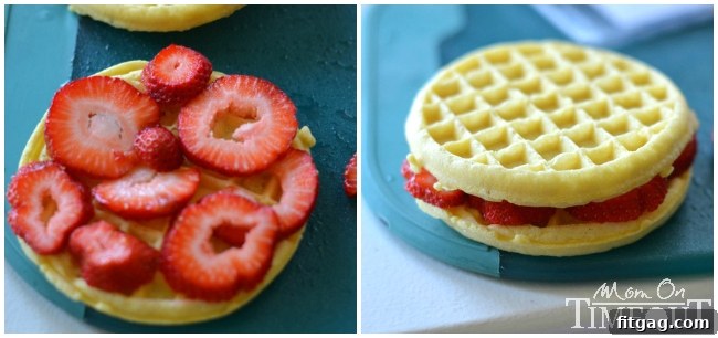 Waffle breakfast prep: Sliced strawberries between two toasted Eggo waffles for a delicious filling.