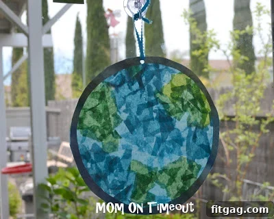 A beautifully crafted Stained Glass Planet Earth glowing in natural light, showcasing vibrant blues and greens.