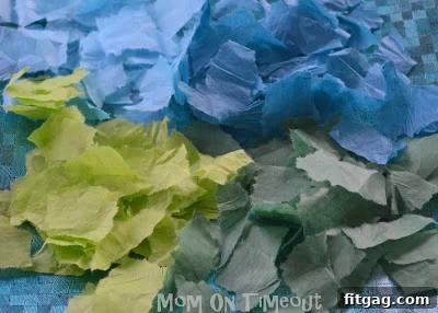 Wax paper unfolded, with glue spread thinly on one half, ready for tissue paper application.