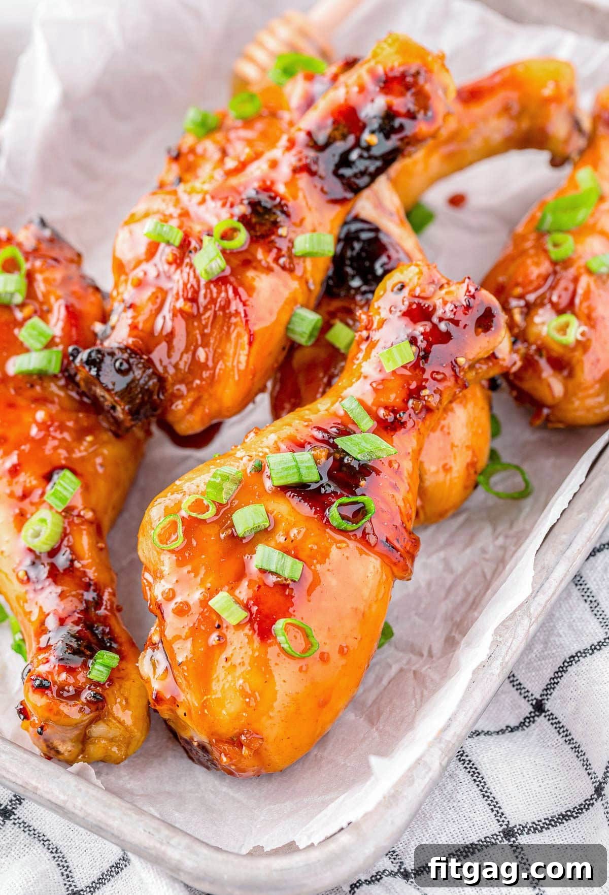 Honey Glazed Chicken drumsticks laying on a tray.