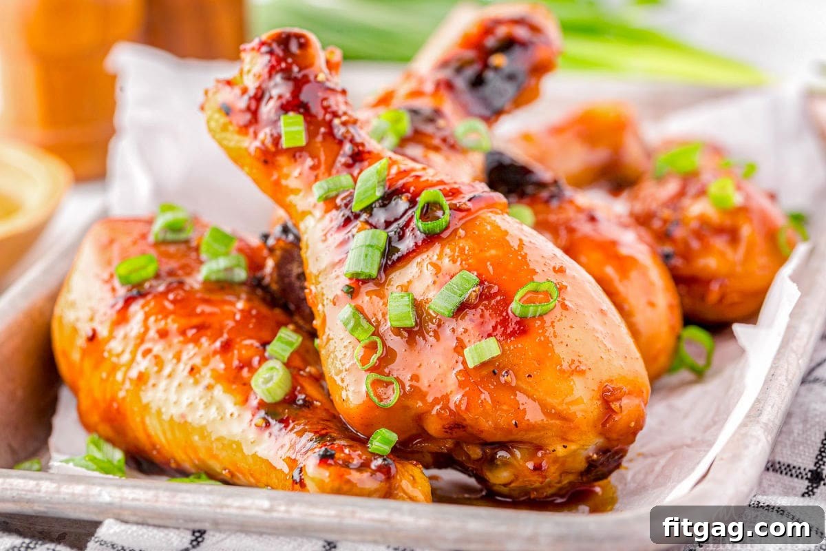 Honey Glazed Chicken drumsticks laying on a tray.