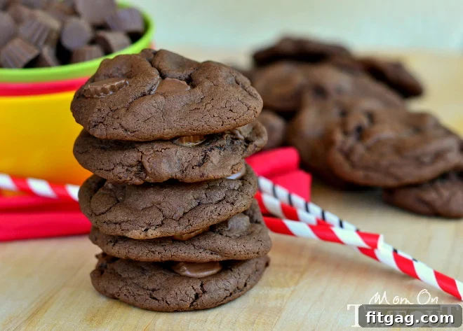 Close-up of a soft, chewy Chocolate Peanut Butter Cup Cookie with visible Reese's Minis