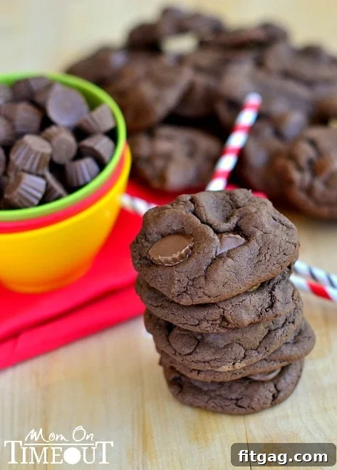 A stack of freshly baked Chocolate Peanut Butter Cup Cookies ready to be enjoyed
