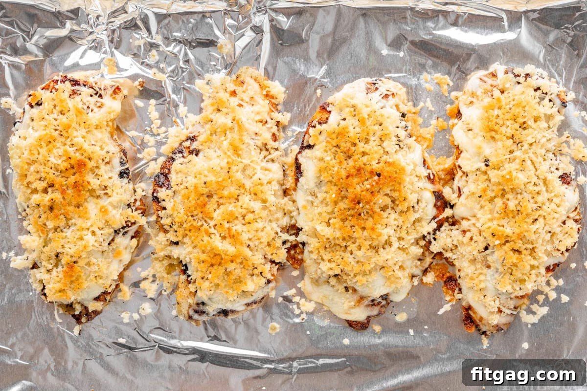 Longhorn Steakhouse Parmesan Crusted Chicken on foil lined pan.