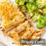Longhorn Parmesan Crusted Chicken on a white plate next to a side of broccoli.