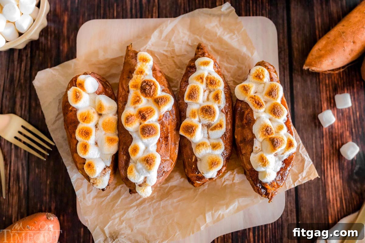 Twice baked sweet potatoes on a piece of parchment paper that's on a wood cutting board.