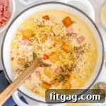 Chicken Cordon Bleu Soup in a dutch oven with wood spoon.