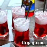 Cherry Italian Cream Soda in a glass with a cherry garnish