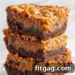 A stack of chocolate pumpkin cheesecake bars on a white plate.