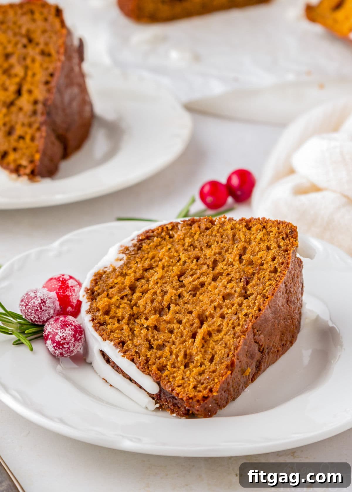 A slice of gingerbread bundt cake on a white plate.
