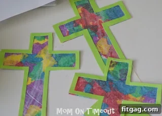 Cutting out the finished stained glass cross from the wax paper