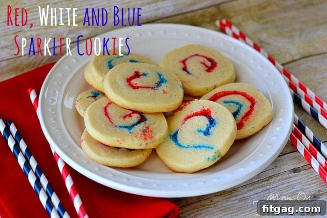 Freshly baked Red, White, and Blue Sparkler Cookies arranged on a cooling rack, showcasing their vibrant pinwheel design and delicious golden edges. Perfect patriotic treats for any holiday.