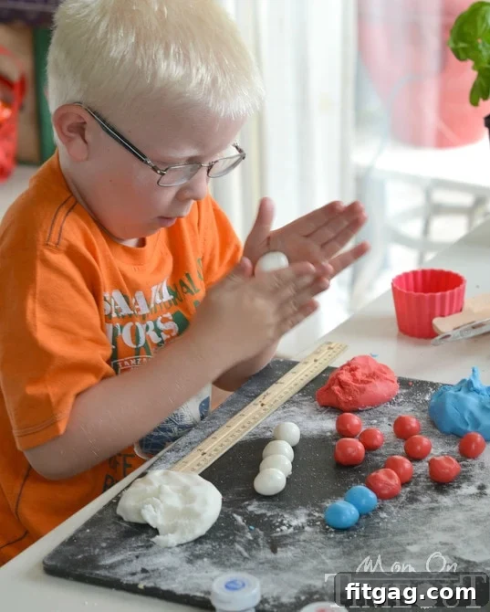 Star Spangled Peppermint Patties 2 Young boy rolling candy dough into balls, participating in making patriotic peppermint patties.