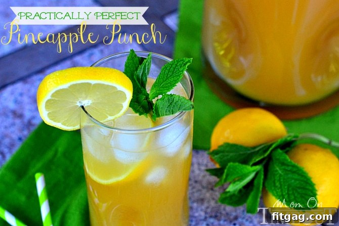 Delicious and refreshing Practically Perfect Pineapple Punch served over ice with lemon and mint garnish