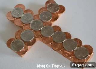 Gluing copper pennies onto a painted wooden cross, a careful step in the 'Paid In Full' Easter craft.