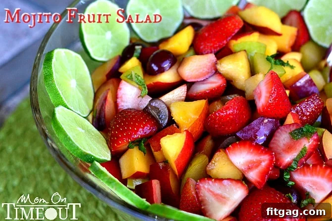 Close-up of Mojito Fruit Salad in a bowl, showing a mix of chopped fruits with mint leaves and a light dressing.