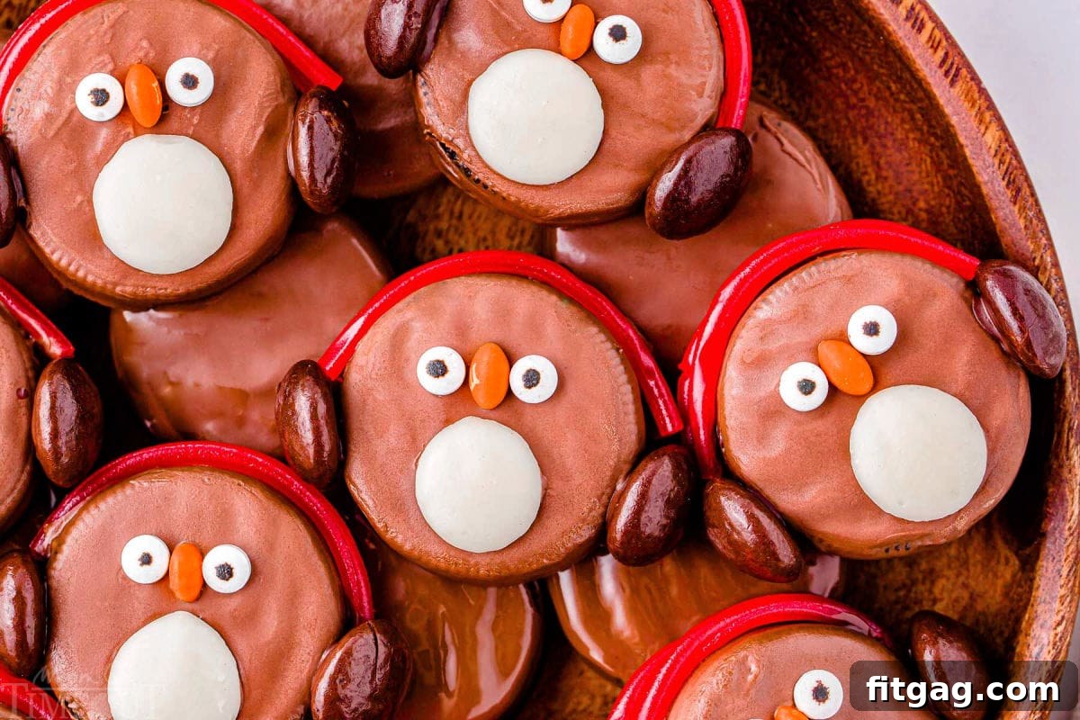 Arctic Oreo Treats 3 Top down look at a dozen penguins made with oreo cookies on a wood tray.