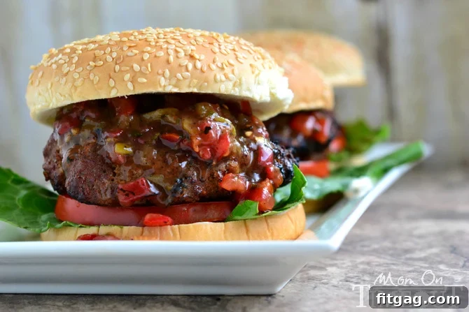 Preparing Juicy Salsa Burgers with Mayonnaise Hand pressing a homemade juicy salsa burger patty before grilling