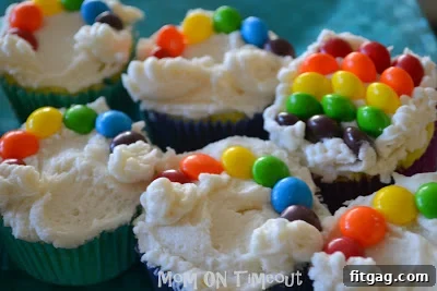 Vibrant Rainbow Bites 6 Delicious rainbow cupcakes topped with colorful Skittles
