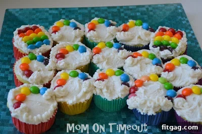 Vibrant Rainbow Bites 7 Rainbow Skittles cupcakes with fluffy marshmallow clouds