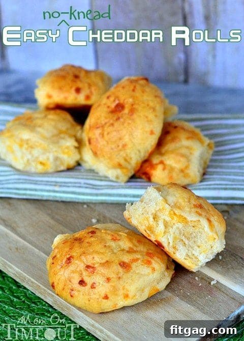 Easy No-Knead Cheddar Rolls | MomOnTimeout.com A basket of freshly baked Easy No-Knead Cheddar Rolls, steaming and golden.