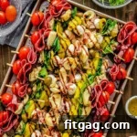 Top down view of antipasto skewers on a sheet pan drizzled with balsamic glaze and ready to eat.