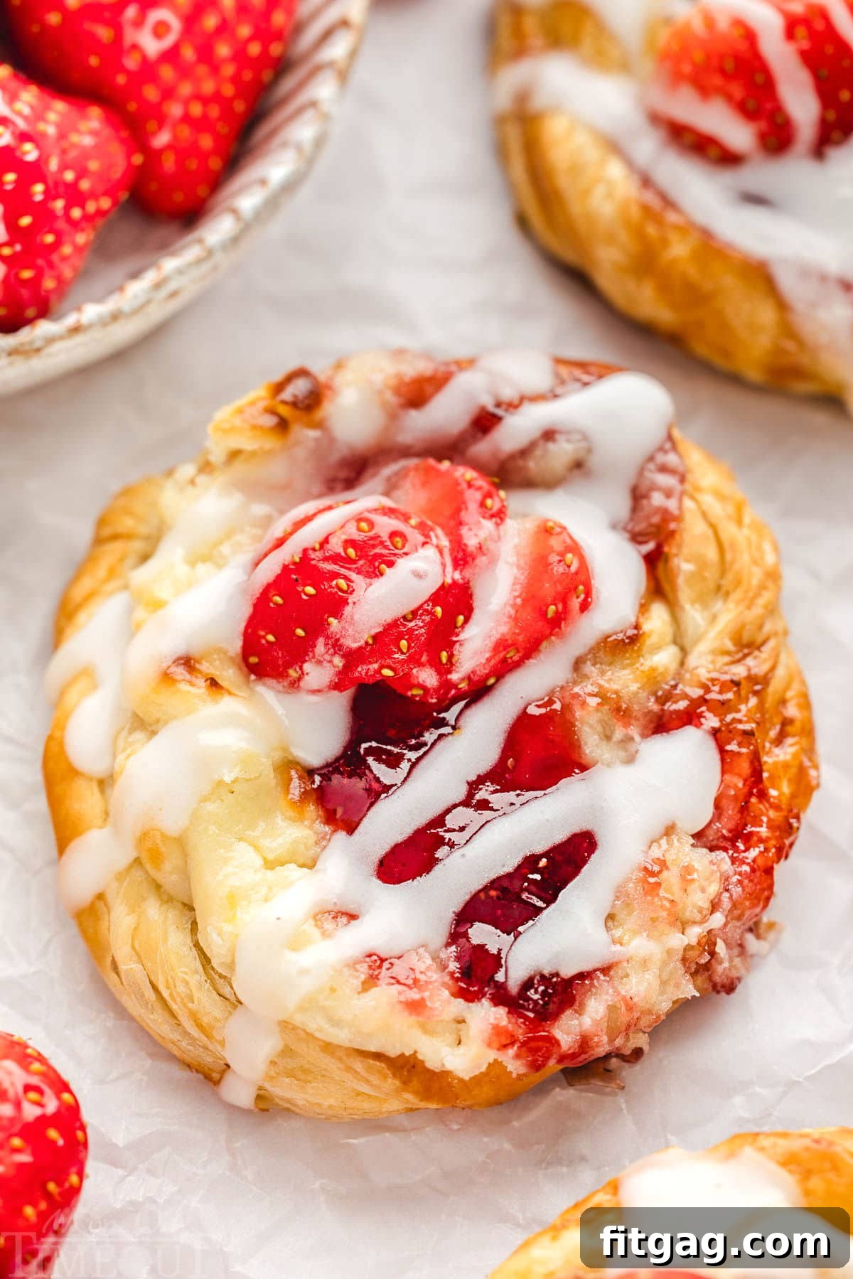 Strawberry Danish Delight 9 A close-up of a beautifully glazed Strawberry Danish with cream cheese and fresh strawberries, highlighting the intricate details of the pastry.