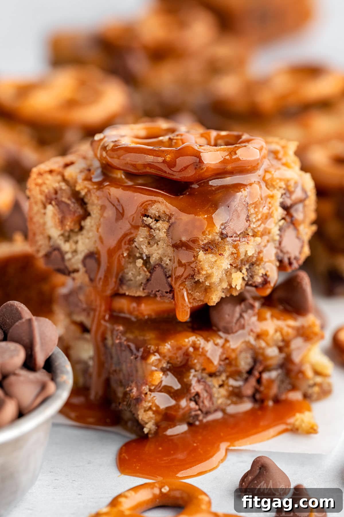 Salted Caramel Blondies in a stack with a drizzle of salted caramel on top.