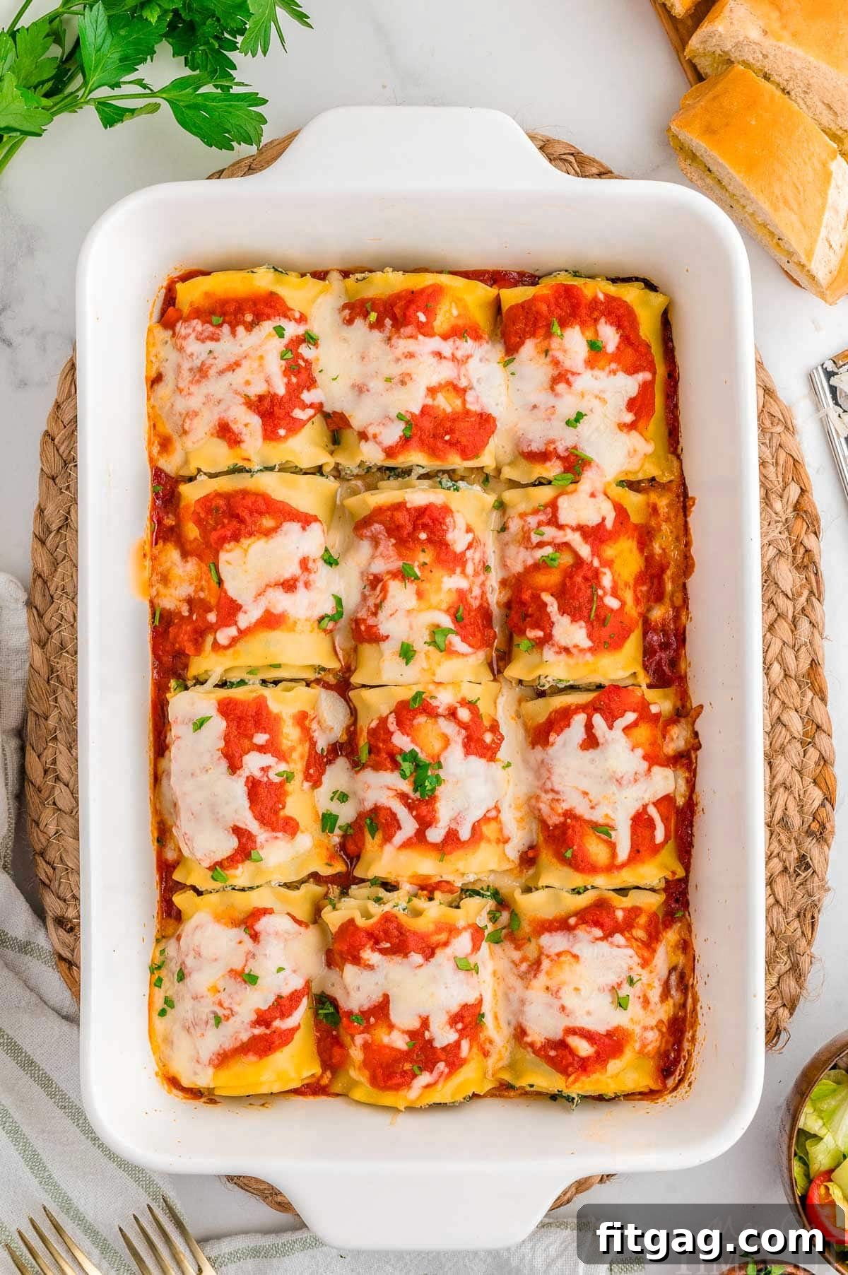 Lasagna Pinwheels 3 Top down shot of lasagna roll ups in a white casserole dish baked and ready to be served.
