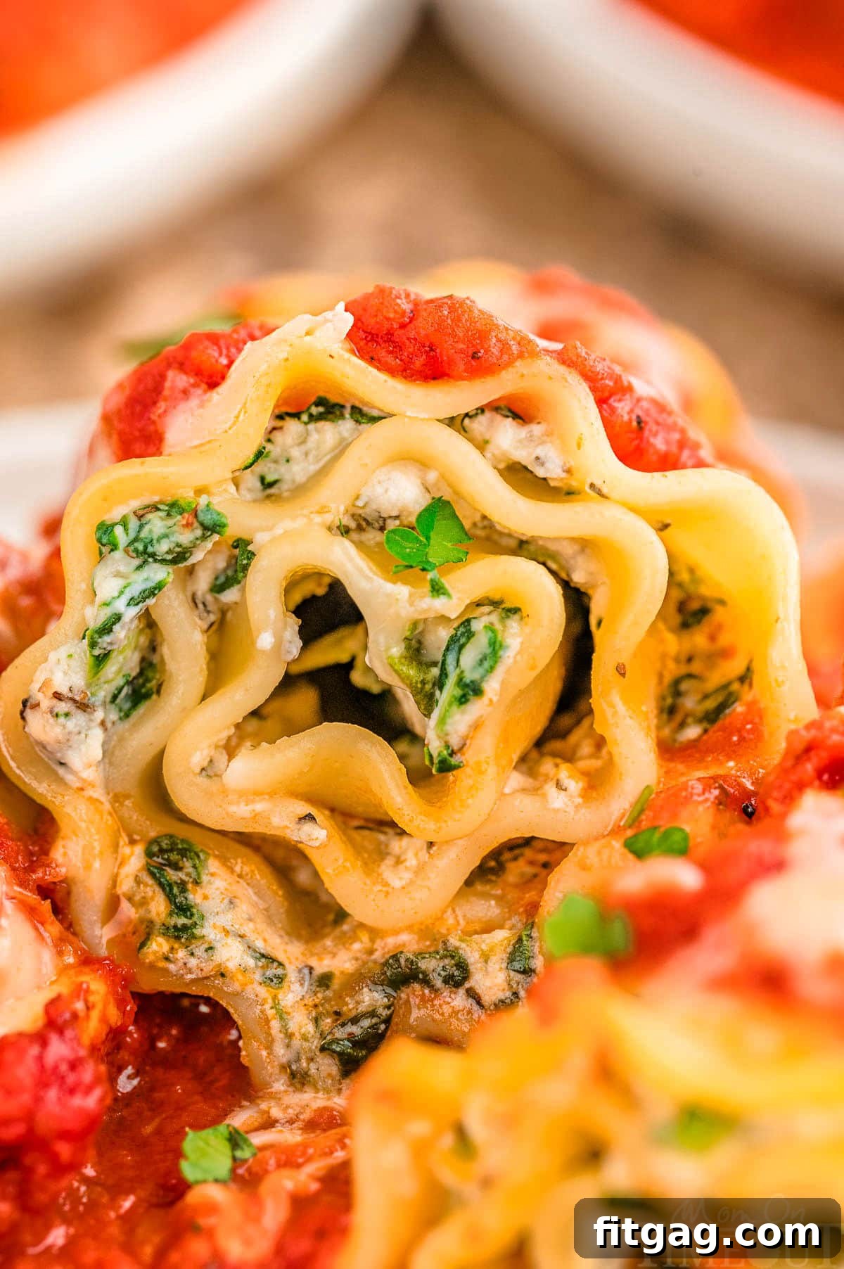 Lasagna Pinwheels 7 Close up look at lasagna roll up on plate.