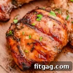 Grilled balsamic chicken marinated in balsamic chicken marinade sitting on wood board.