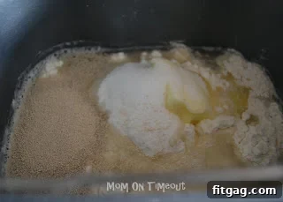 Adding ingredients to the bread machine for pizza dough.