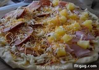 Pizza ready to bake with golden crust and bubbly cheese.