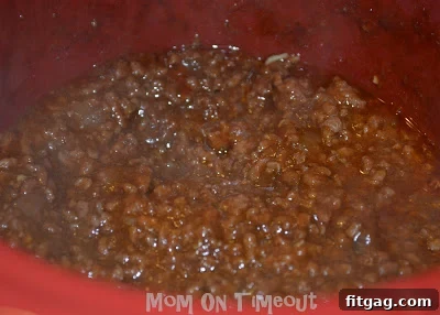 A perfectly assembled Sloppy Joe on a toasted bun, ready to eat.