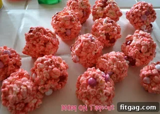 Sweet Valentine's Popcorn Balls 9 Forming sticky popcorn and M&M mixture into round balls.