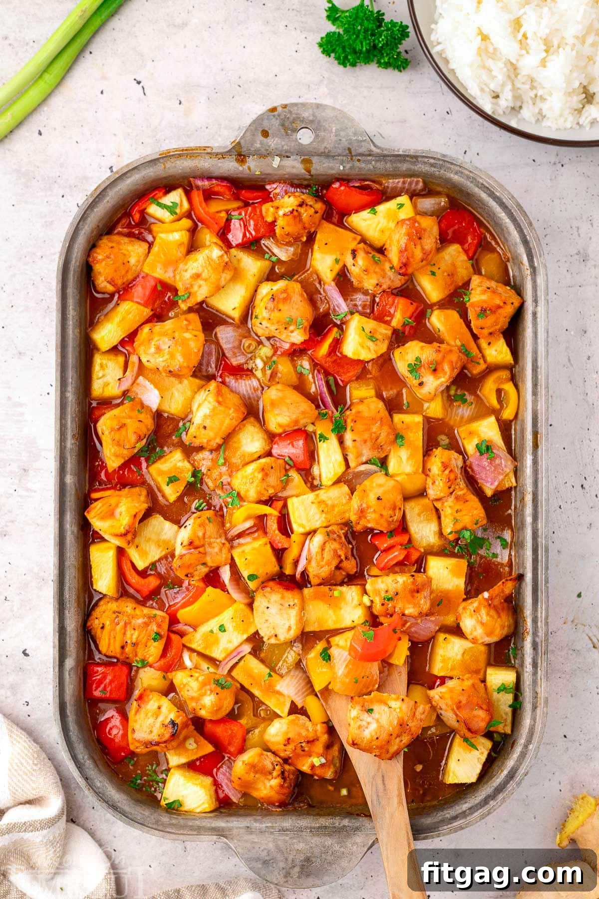 Overhead view of Hawaiian Chicken sheet pan recipe still in the sheet pan ready to be served, showcasing the beautiful caramelization and colorful ingredients.