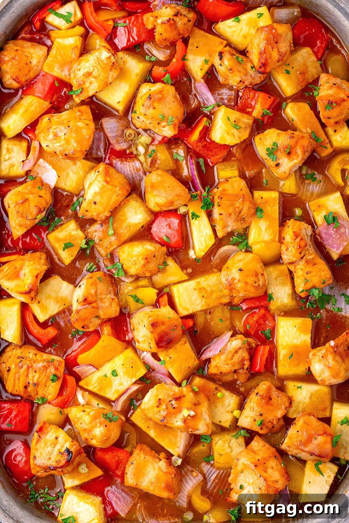 Hawaiian Chicken sheet pan recipe close up so you can see the marinade and ingredients well, with a rich, glossy glaze.