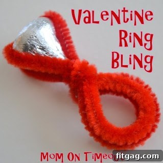 A child's hand modeling a pink Hershey's Kiss ring, a sweet 'pink sapphire' for Valentine's.