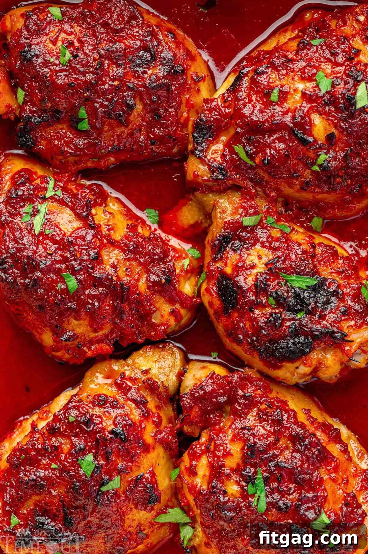 Close up of harissa honey chicken in baking dish.